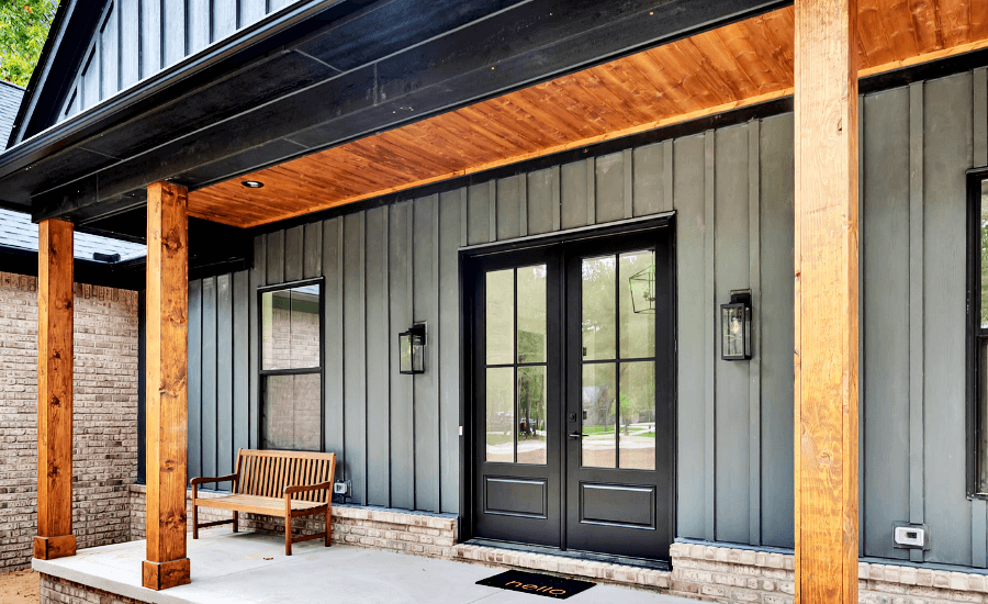 New home with stained wood beam overhang support and front porch