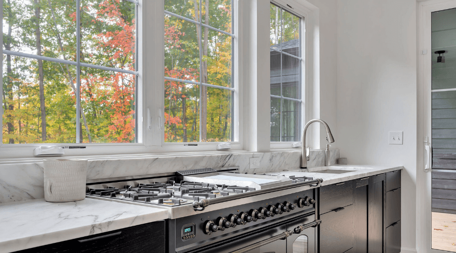 Kitchen with large pane windows to see trees