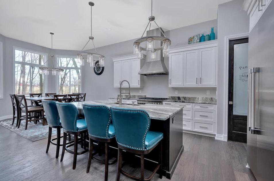 Beautiful kitchen with island seating and stainless steel oven hood