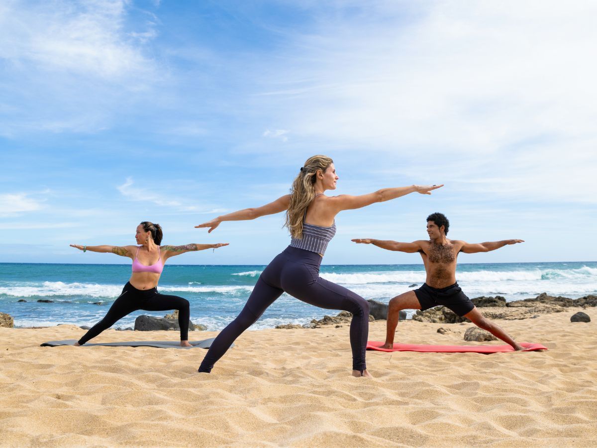 Award-winning sex coach and therapist Stephanie Bathurst leads a couple into yoga in Hawaii during a sex therapy retreat