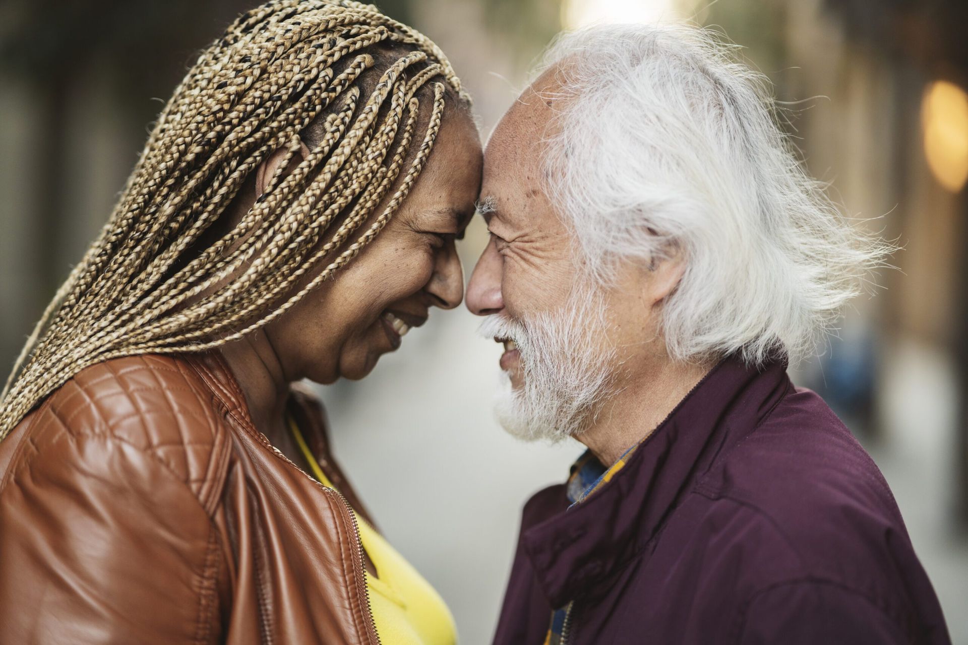 A man and a woman are looking at each other and smiling.