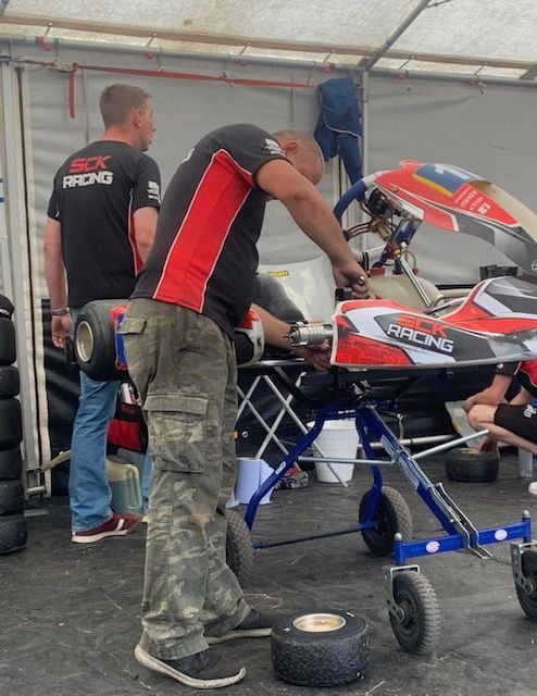 photo of a mechanic working on a sck racing kart 