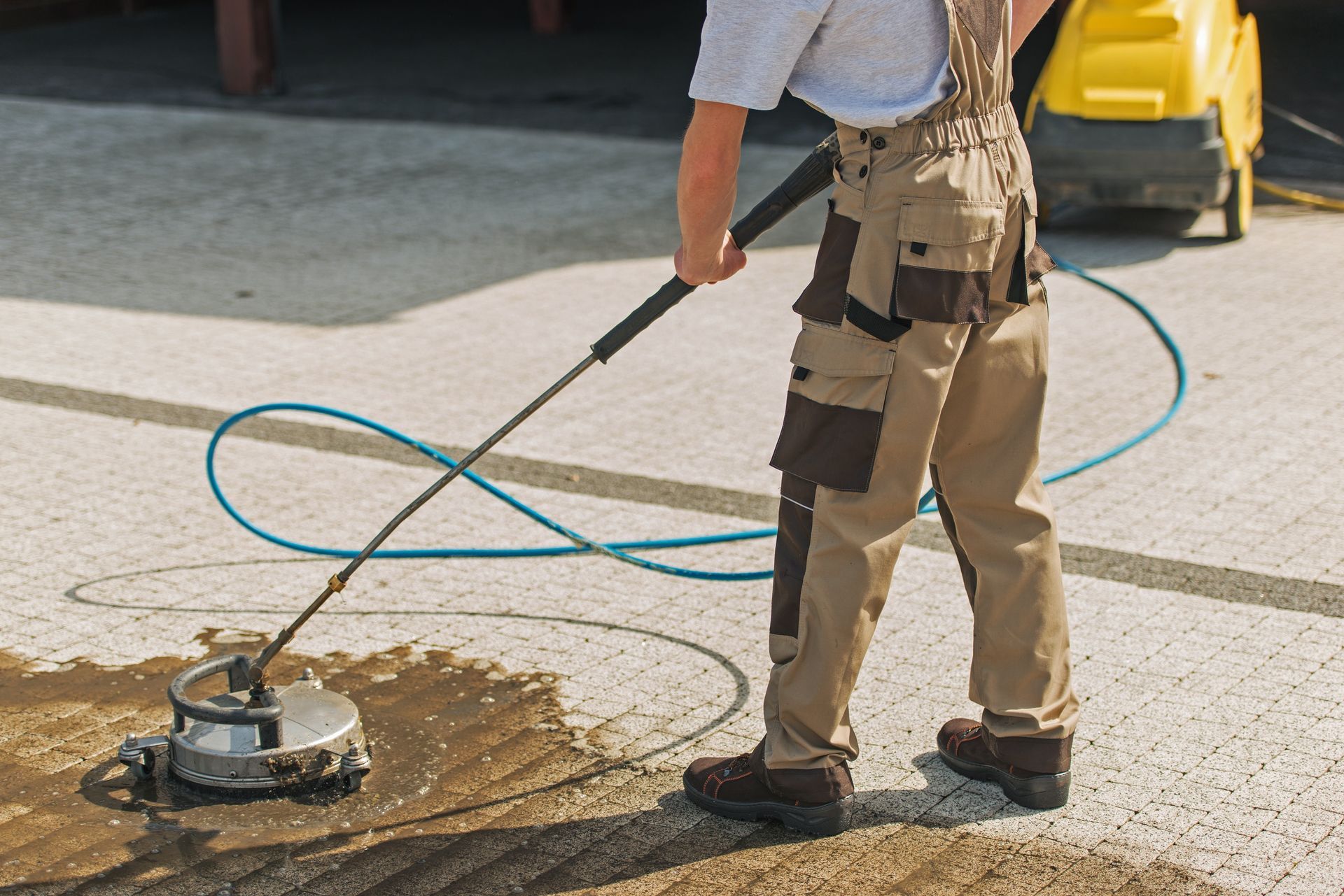 A man is cleaning the ground with a machine.