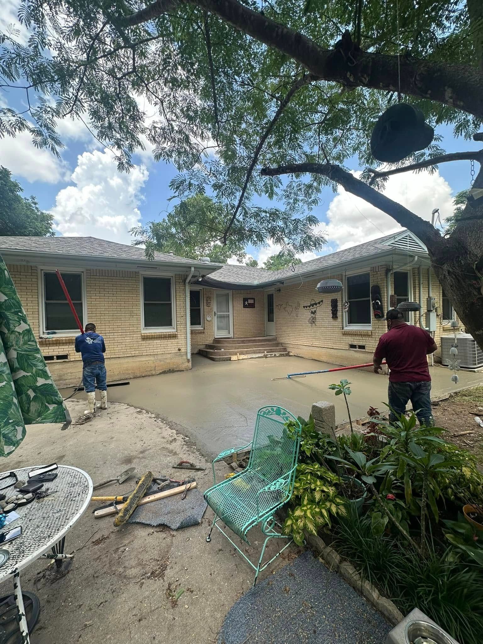 A couple of men are standing in front of a house.