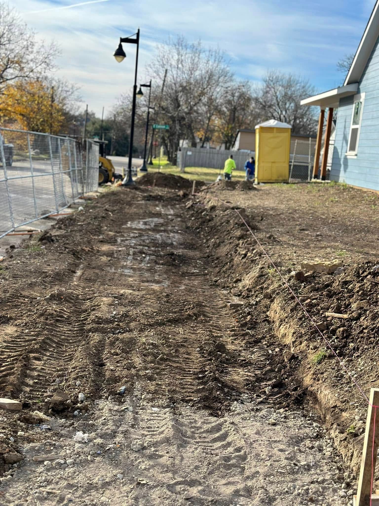 A large pile of dirt is sitting in front of a house.