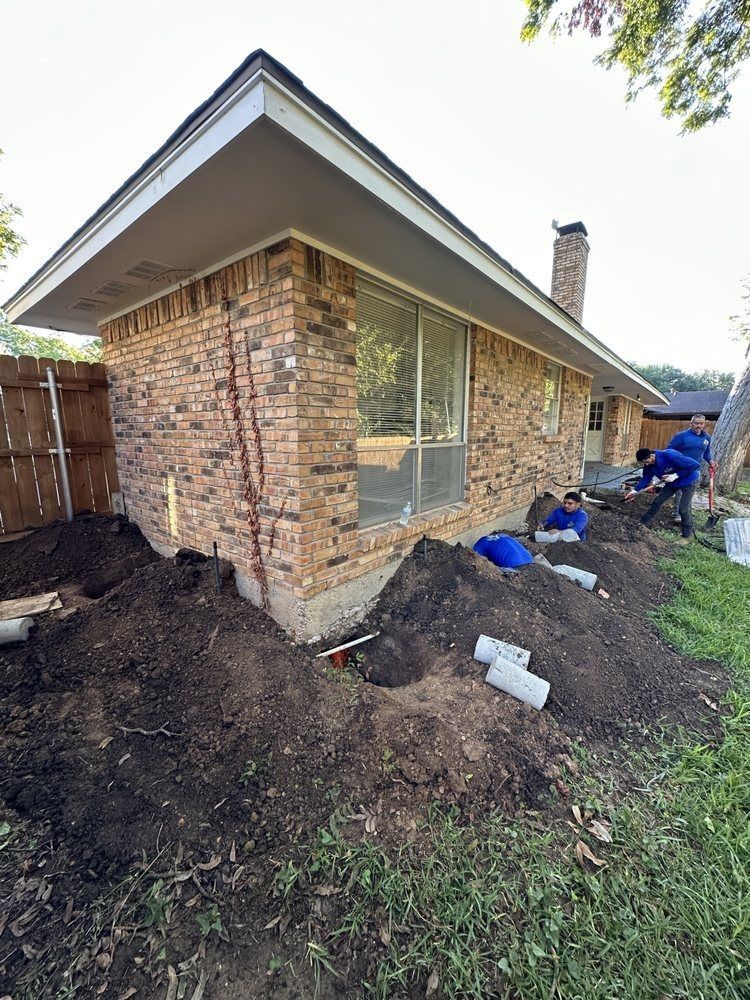 A brick house with a pile of dirt in front of it.