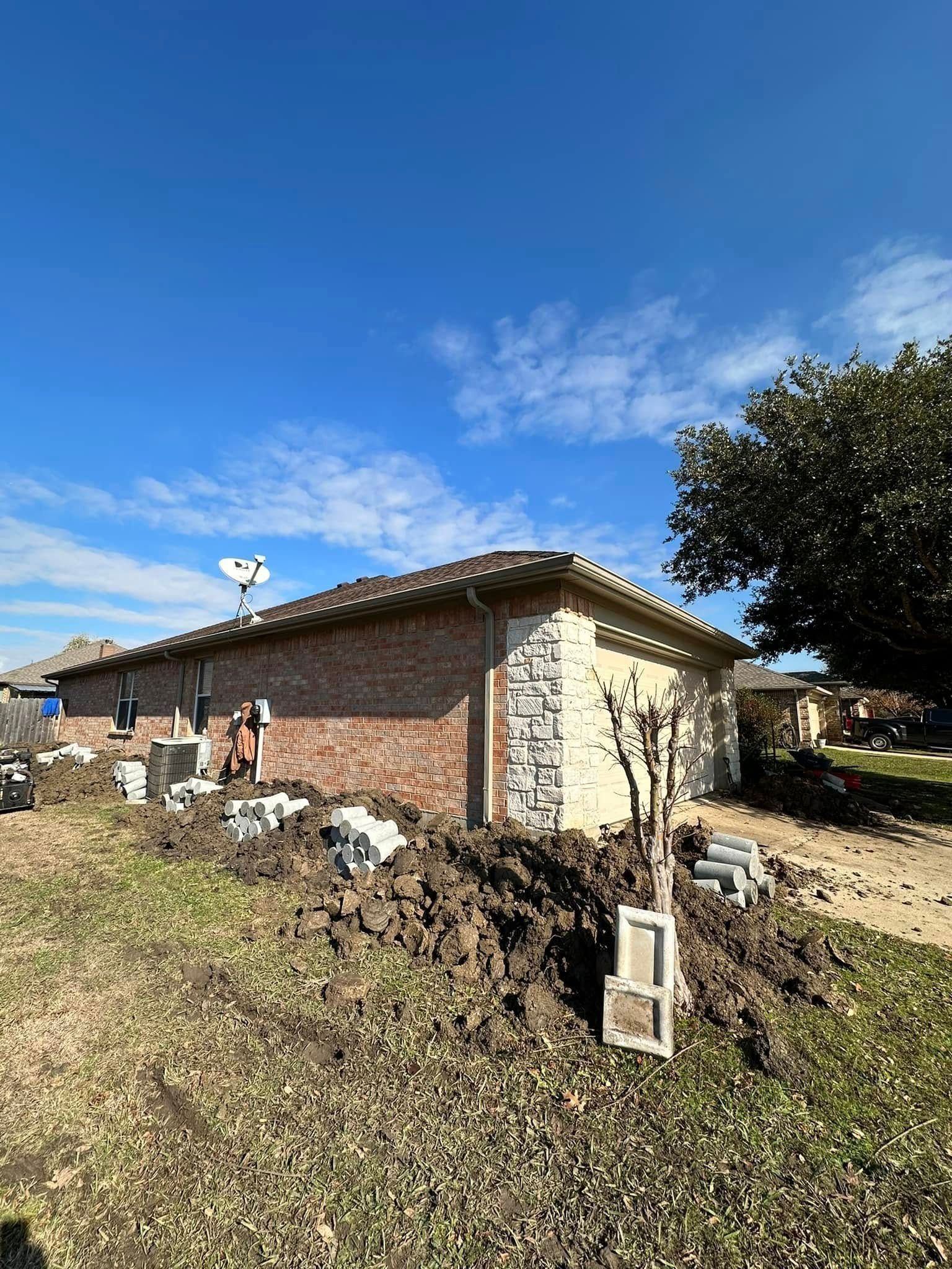 A house with a lot of dirt in front of it.