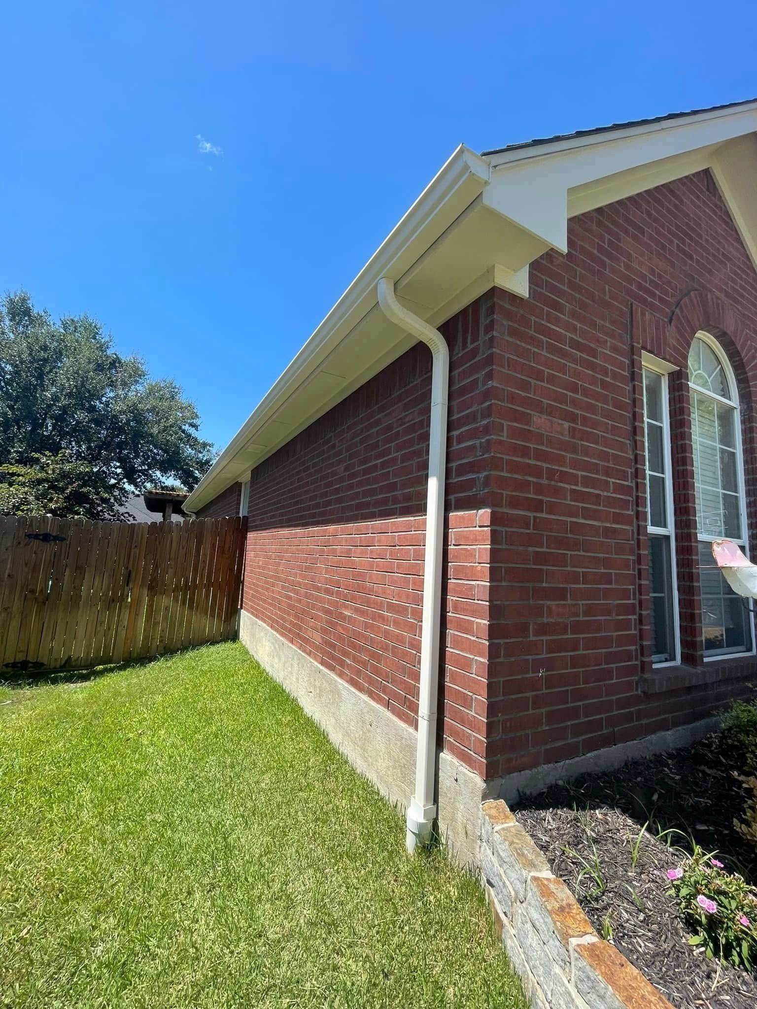 A brick house with a white gutter