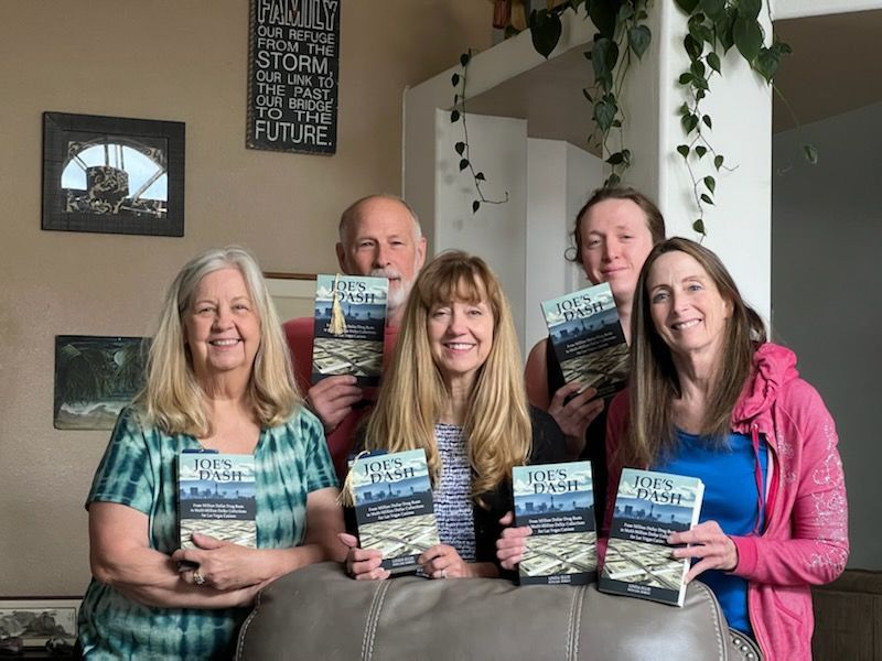 Group of people posing with Joe's Dash Book