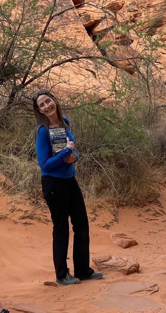 Woman posing with Joe's Dash book outdoors
