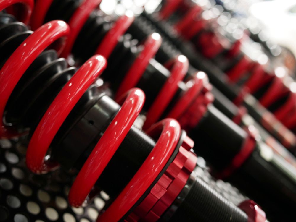 A Close Up of a Red and Black Shock Absorber — Chris Bale Automotive in Toronto, NSW