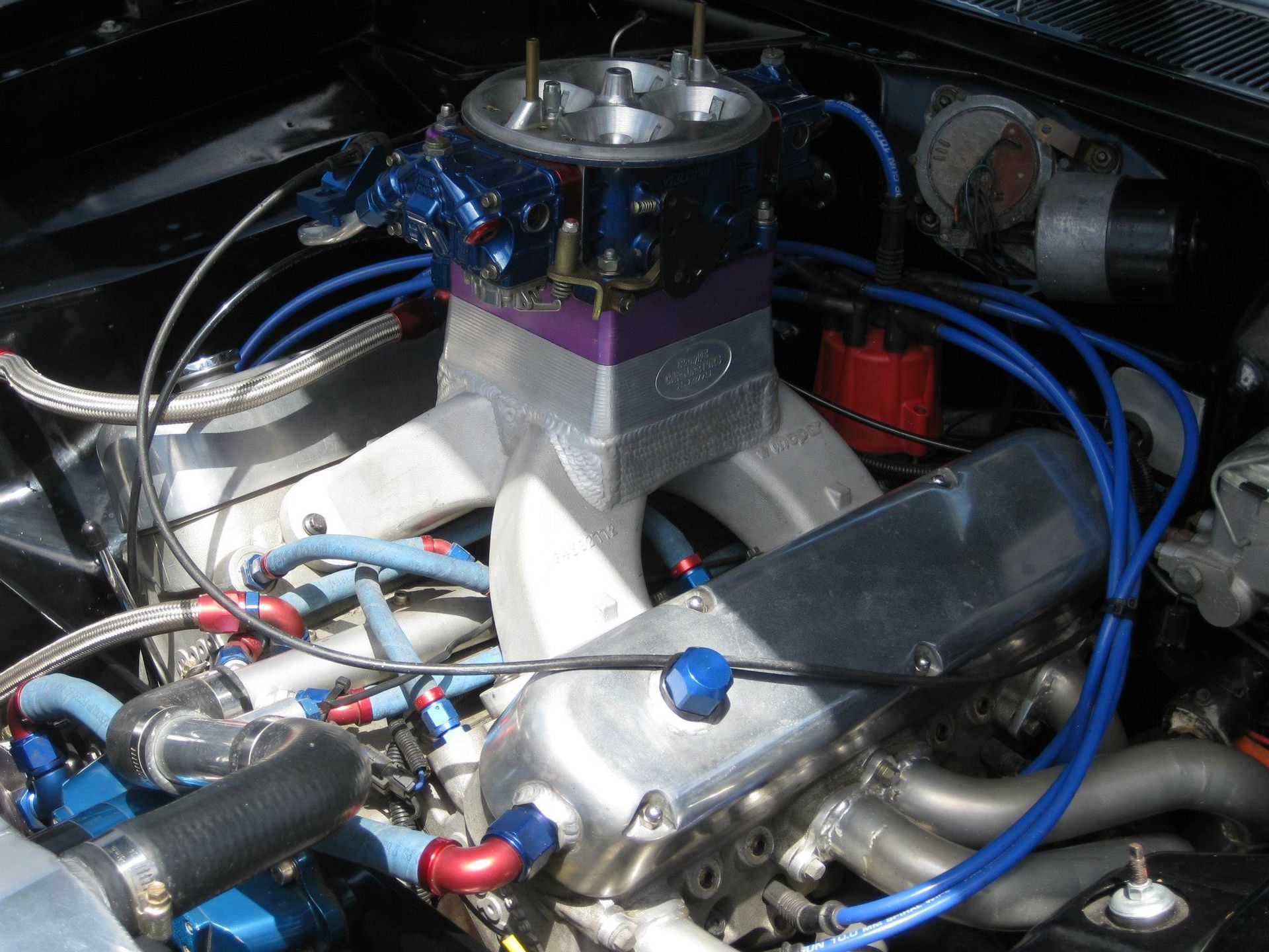 A Close Up of a Car Engine With Blue Wires — Chris Bale Automotive in Toronto, NSW