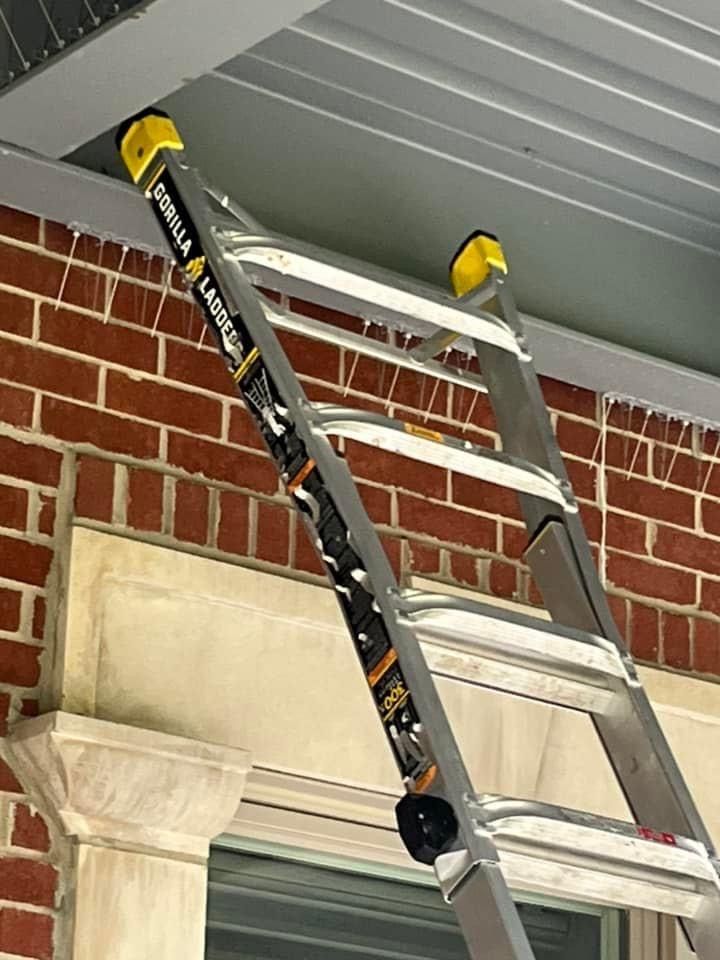 A ladder is leaning against a brick wall.