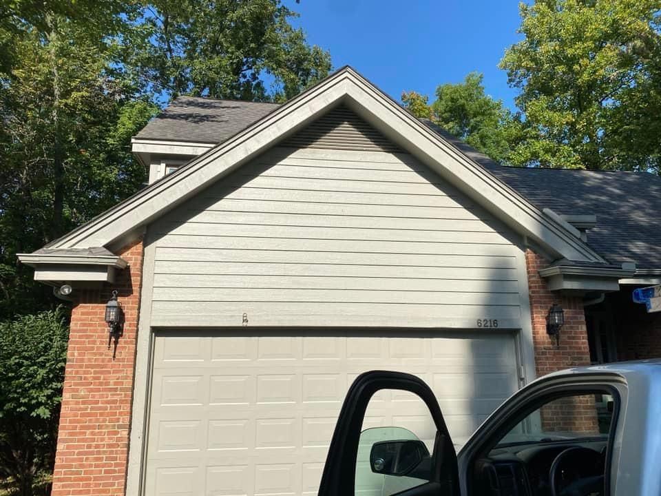 A truck is parked in front of a garage door.