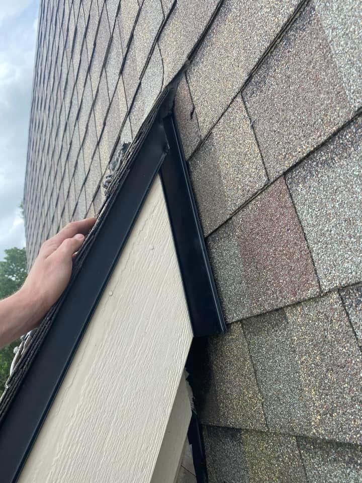 A person is working on the roof of a building.