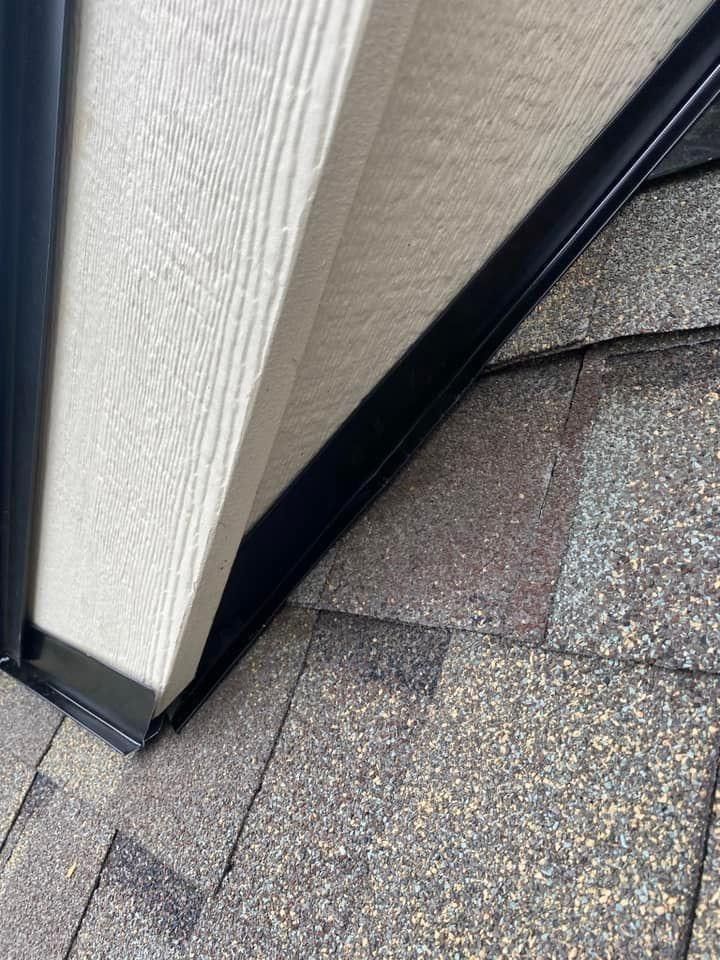A close up of a roof with a gutter on it.