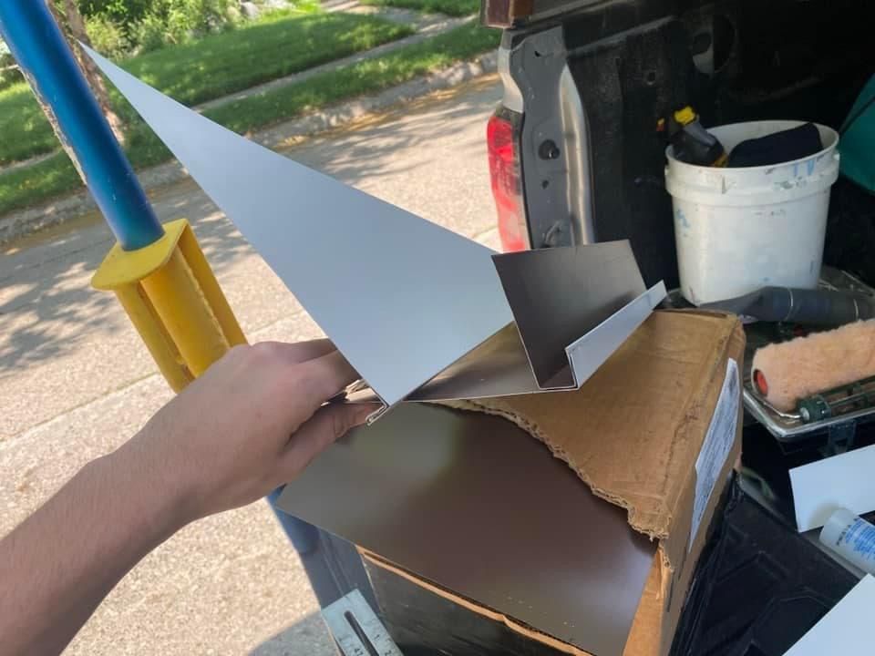 A person is holding a piece of cardboard in their hand