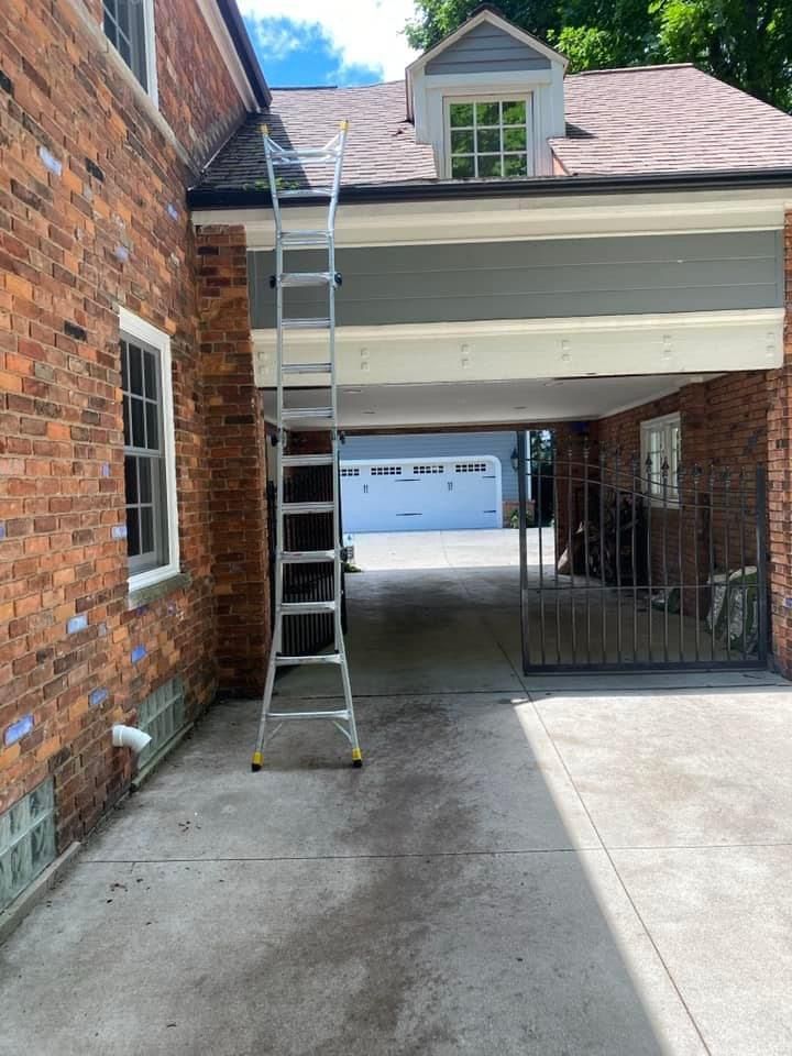 A ladder is attached to the side of a brick house.