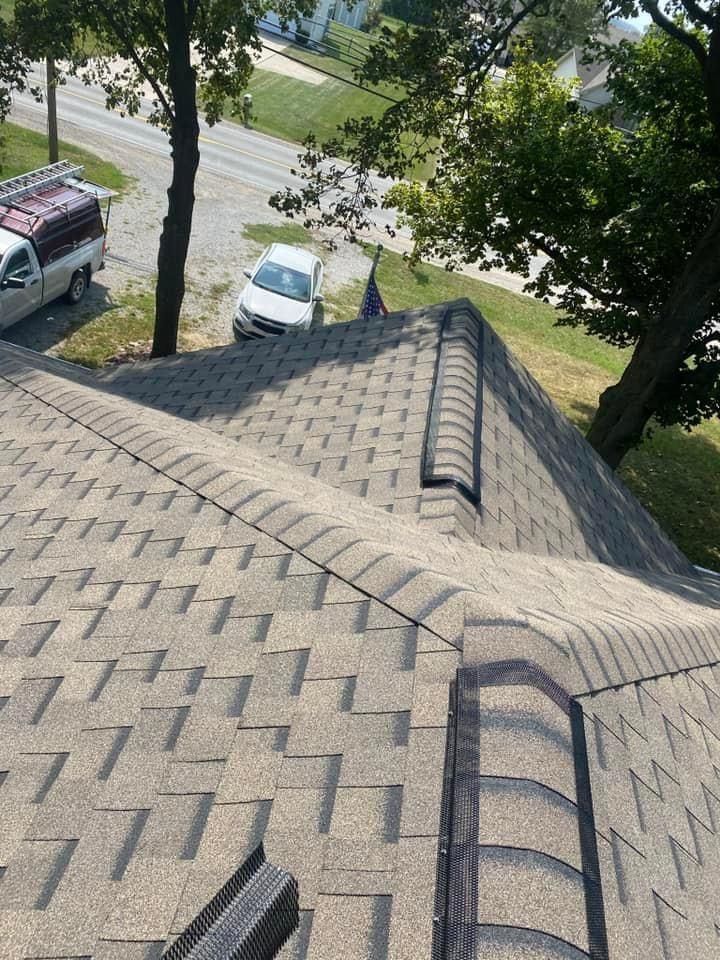 A car is parked on the roof of a house.