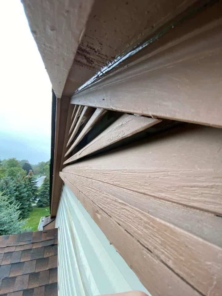A close up of a wooden siding on a house.