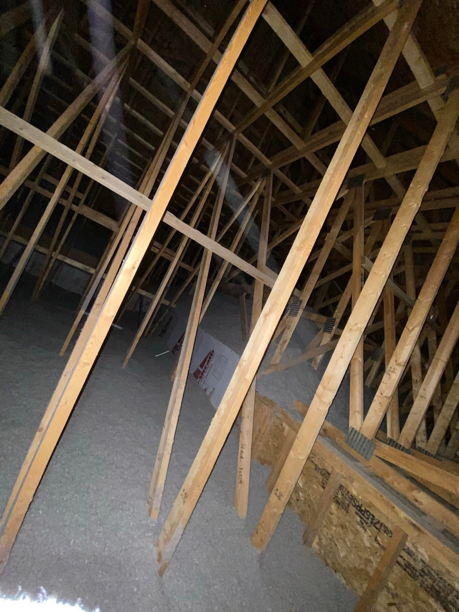 Looking up at the ceiling of a building with wooden beams.