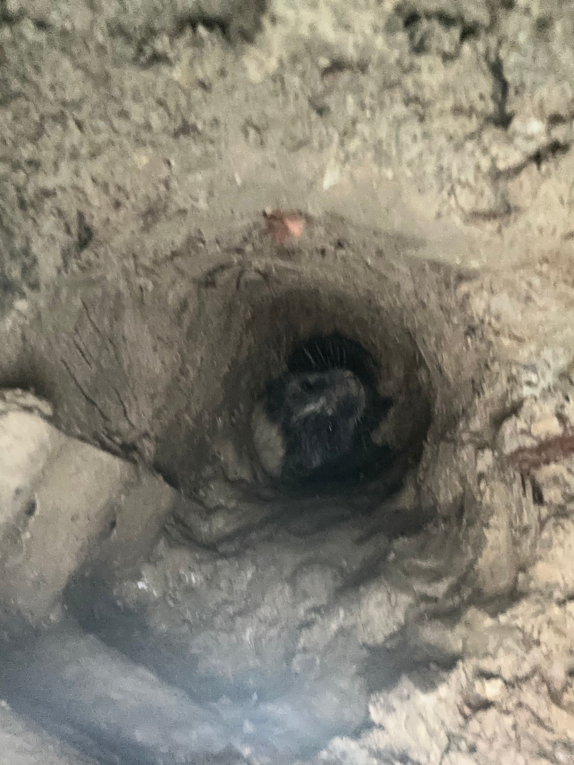 A close up of a hole in a concrete wall.