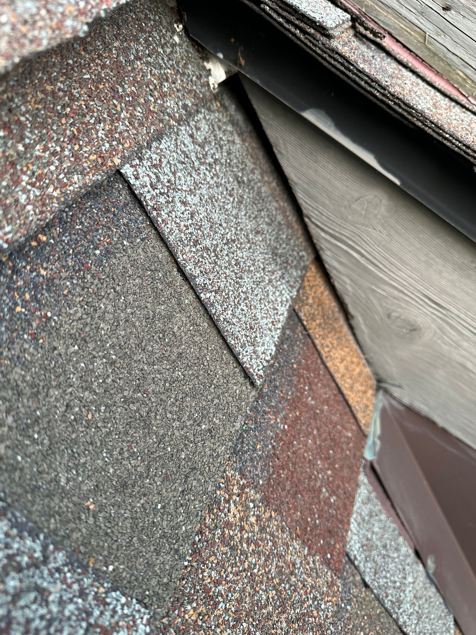 A close up of a roof with a lot of shingles on it.