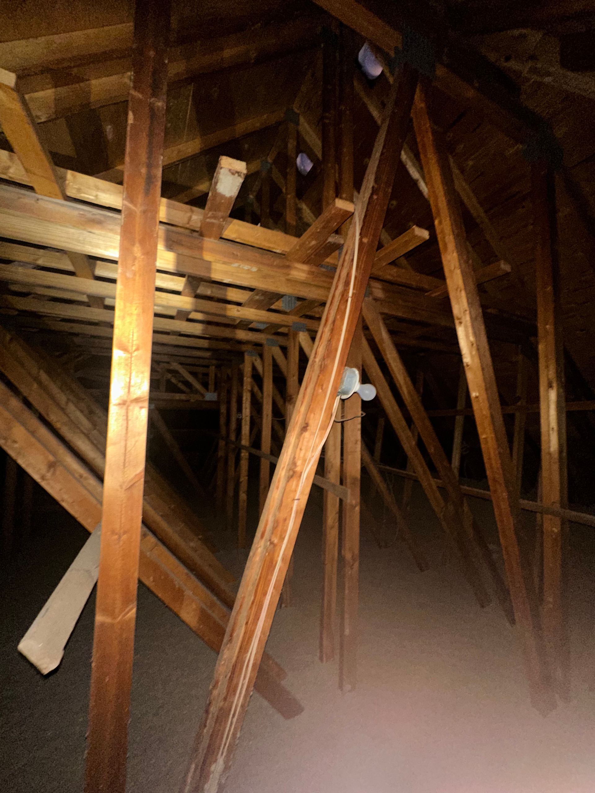 A dark attic with a lot of wooden beams