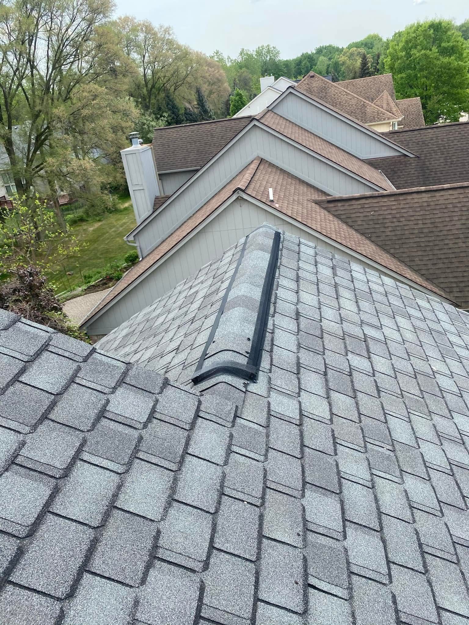 A close up of a roof with a chimney on it.