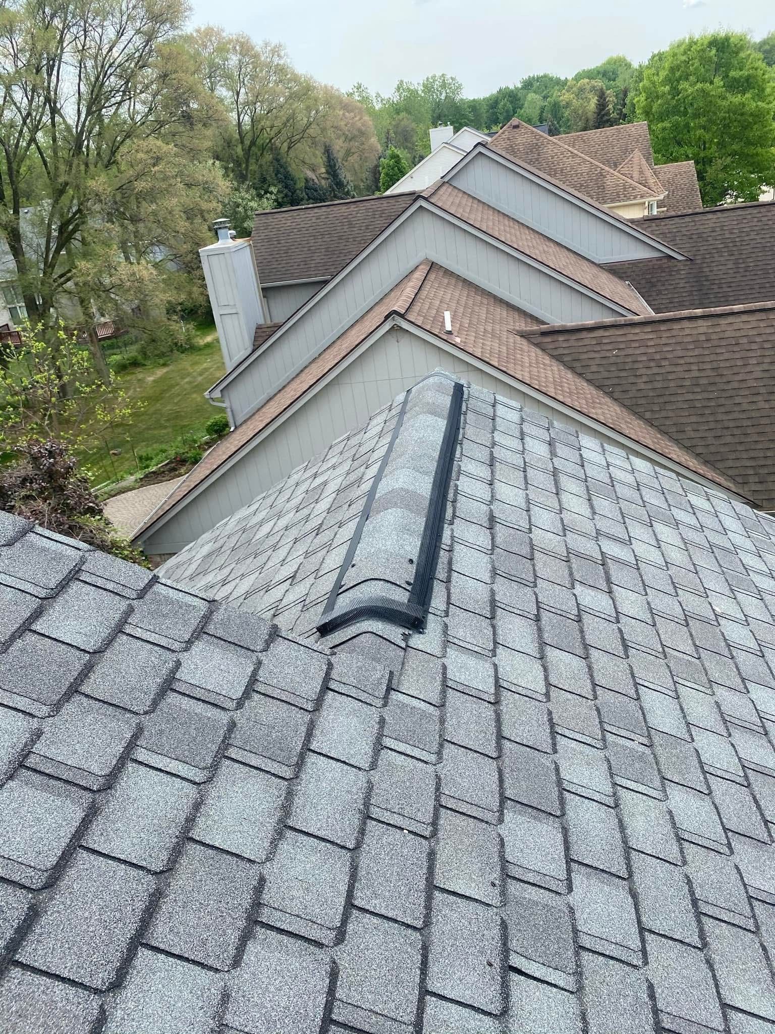 A close up of a roof with a chimney on it.