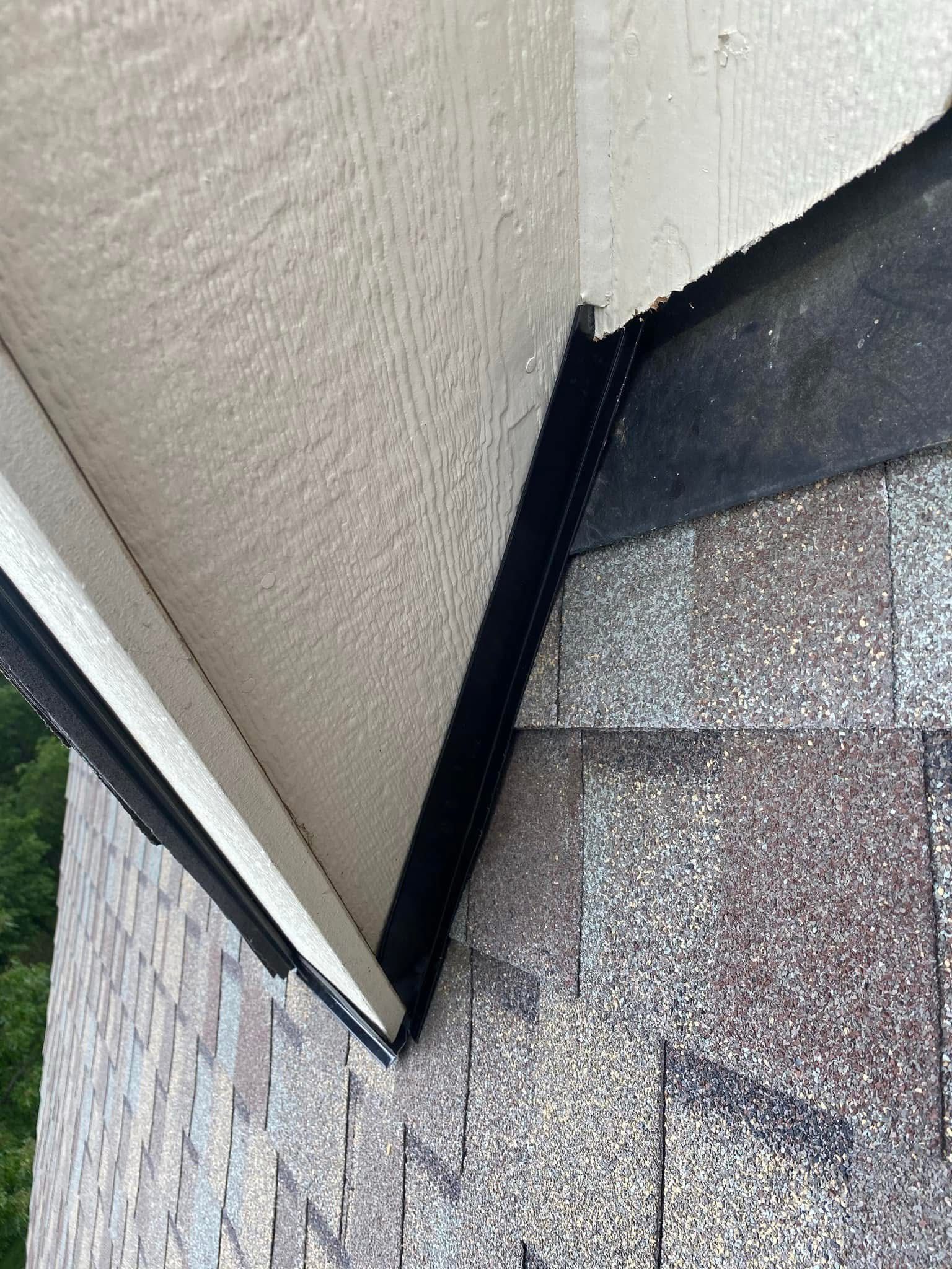 A close up of a roof with a gutter on it.