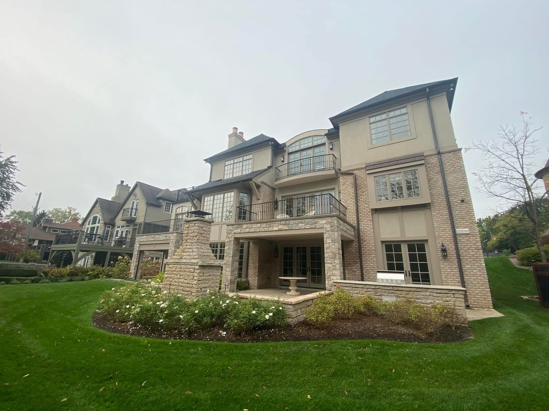 A large house with a lush green lawn in front of it