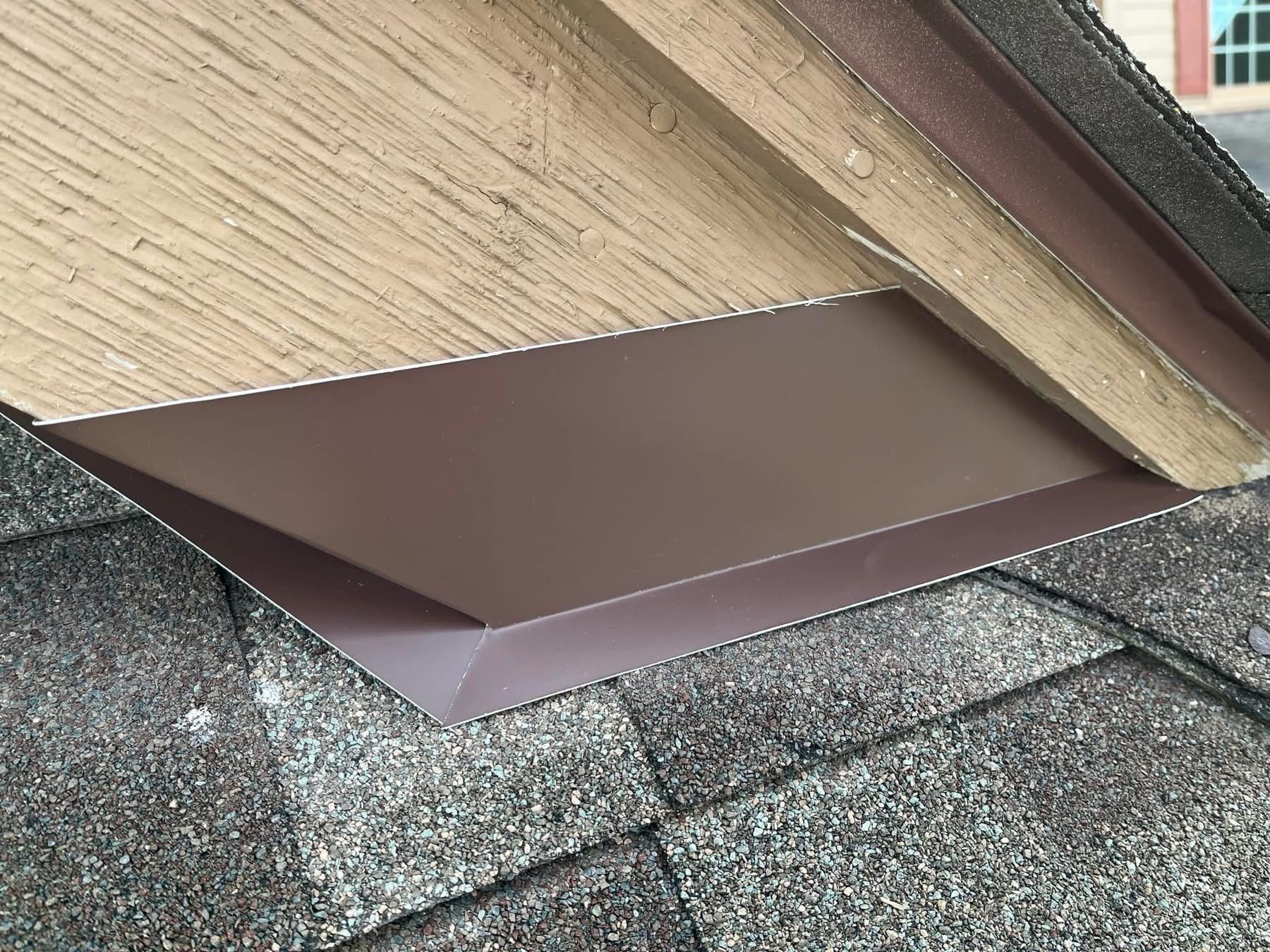 A close up of a roof with shingles and a wooden roof.