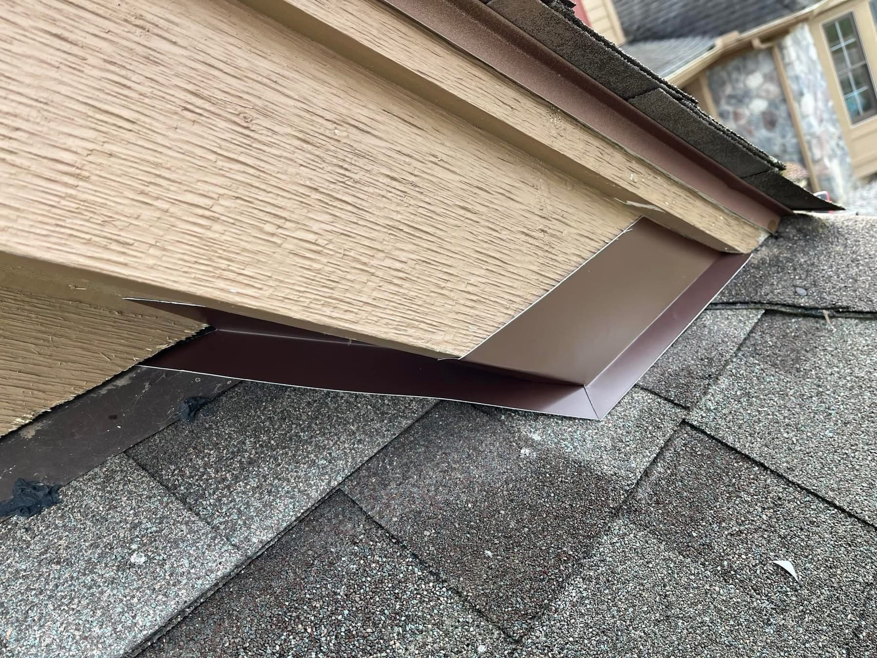 A close up of a roof with a gutter on it.