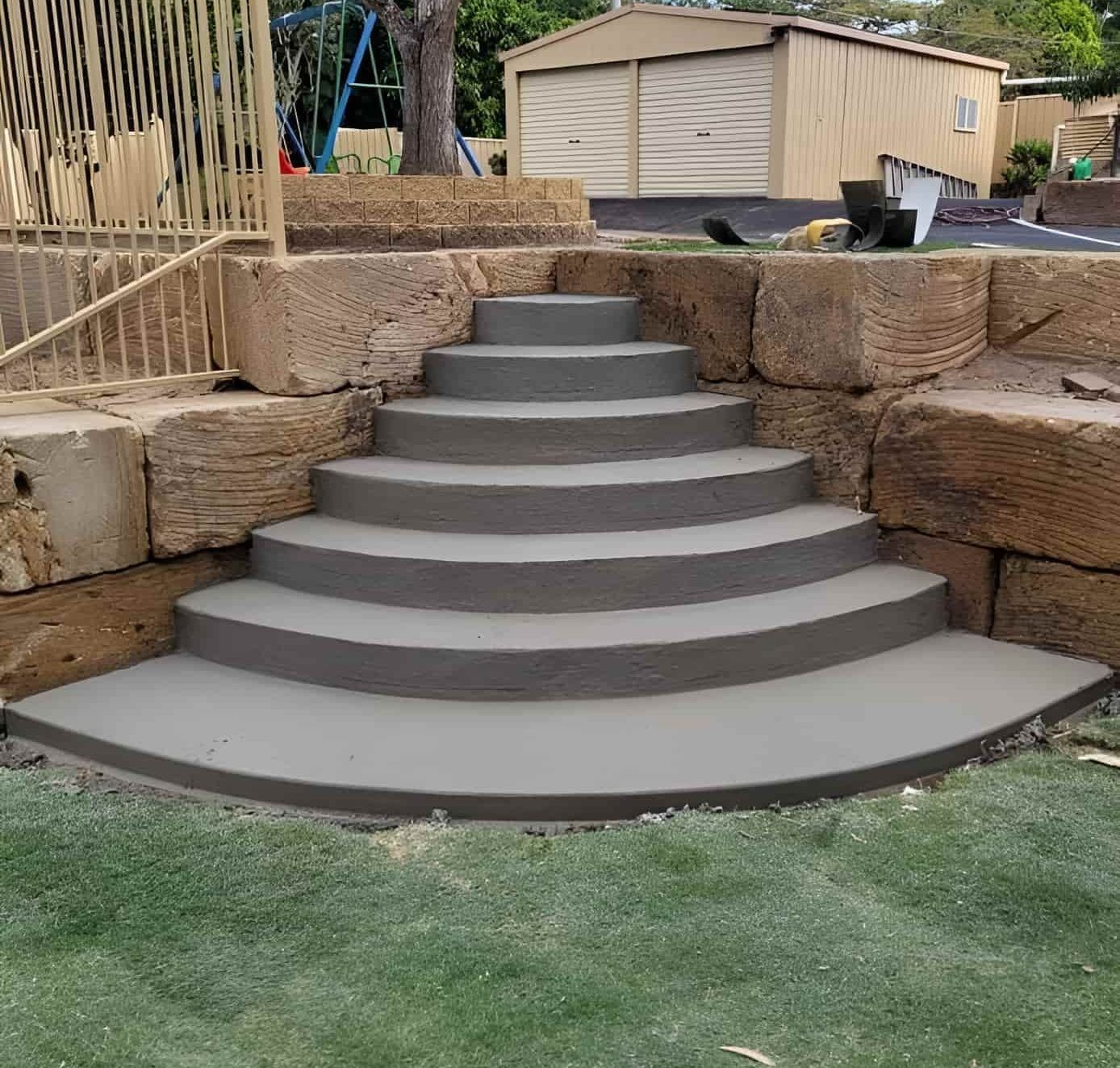 A Set Of Concrete Steps Leading Up To A Stone Wall — C & A Concreting In Craignish, QLD