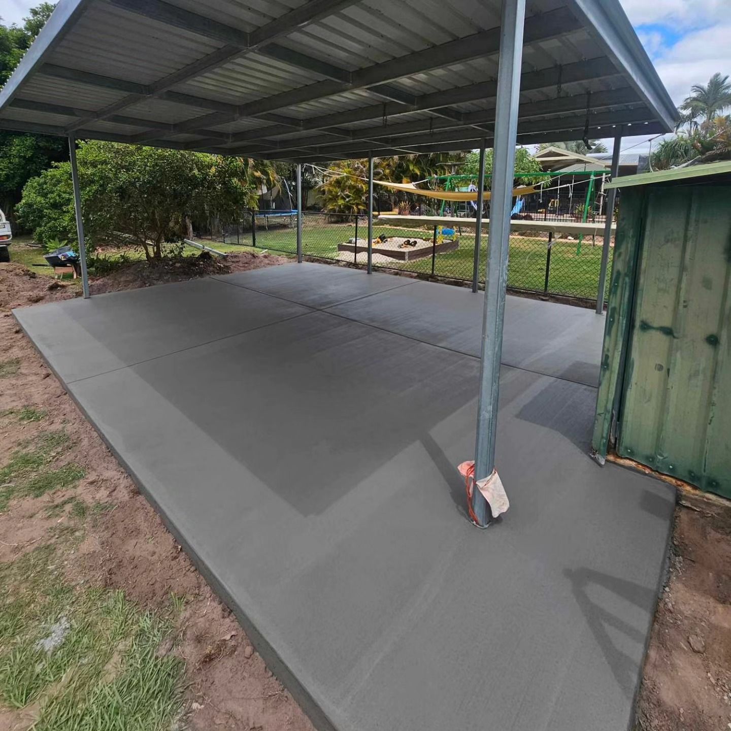 A Concrete Walkway Is Being Built In A Backyard Next To A Fence — C & A Concreting In Craignish, QLD