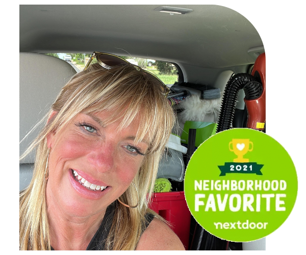 Smiling woman in a car with a 2021 Neighborhood Favorite Nextdoor badge