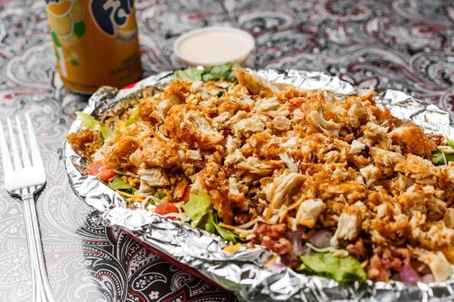 A tray of meat and vegetables on a table.
