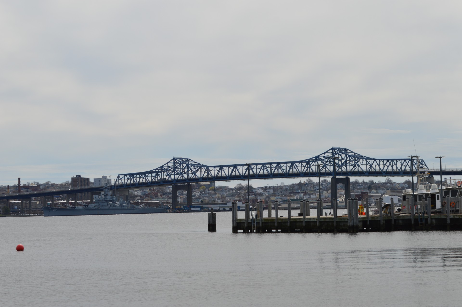 A bridge over a body of water with a dock in the foreground