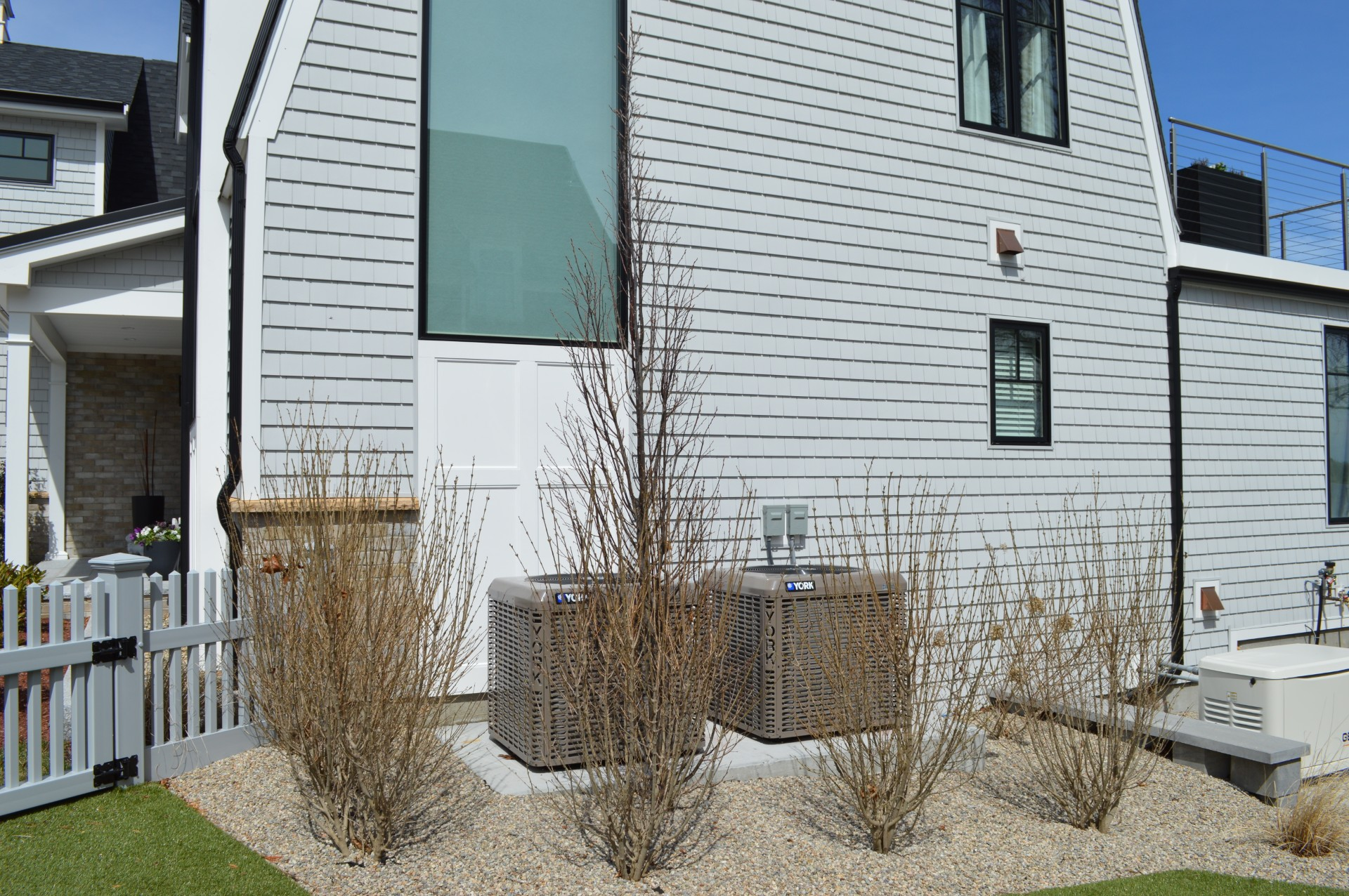 A white house with a white picket fence in front of it.