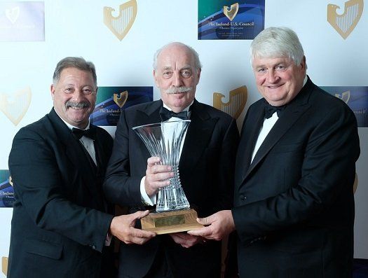 two Ireland-U.S. council members with Dermot Desmond, holding trophy