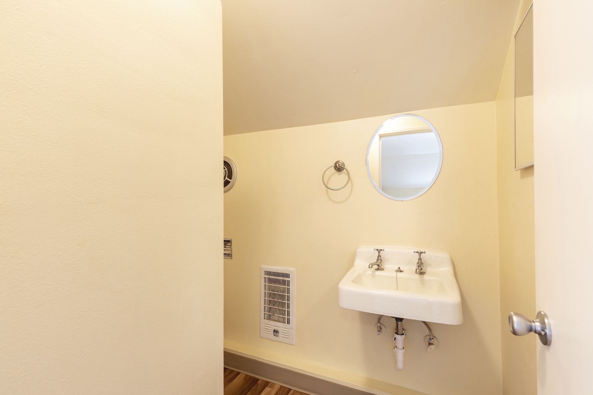 A bathroom with a sink and a mirror on the wall.