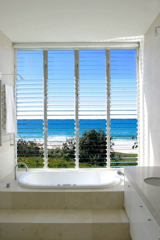 A Bathroom with A Bathtub and A View of The Ocean — North Queensland Glass & Glazing In Cannonvale, QLD