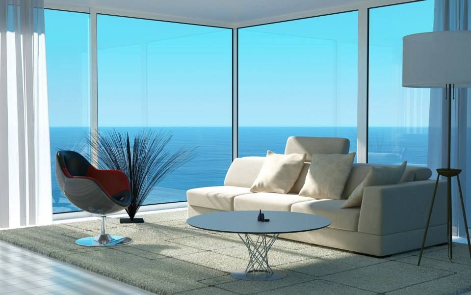 A Living Room with A Couch, Chair, Coffee Table and Large Windows — North Queensland Glass & Glazing In Proserpine, QLD