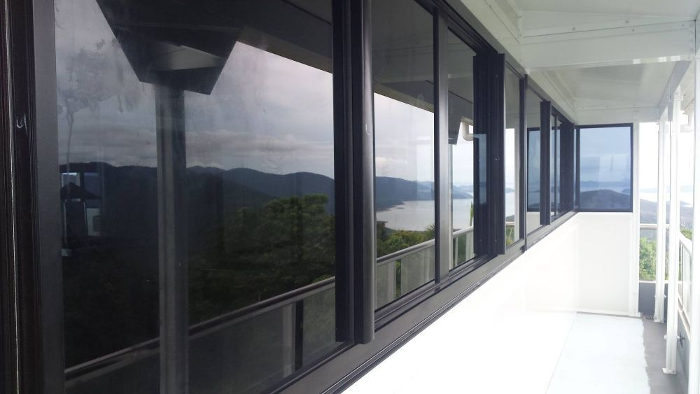 A Long Hallway with A Lot of Windows and A View — North Queensland Glass & Glazing In Cannonvale, QLD