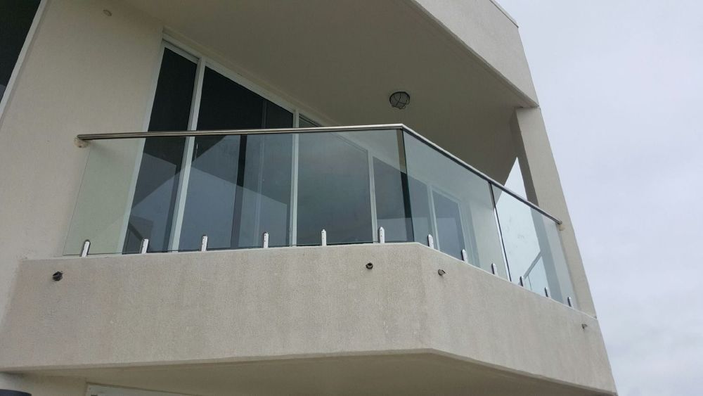 A Balcony with A Glass Railing on The Side of A Building — North Queensland Glass & Glazing In Hamilton Island, QLD