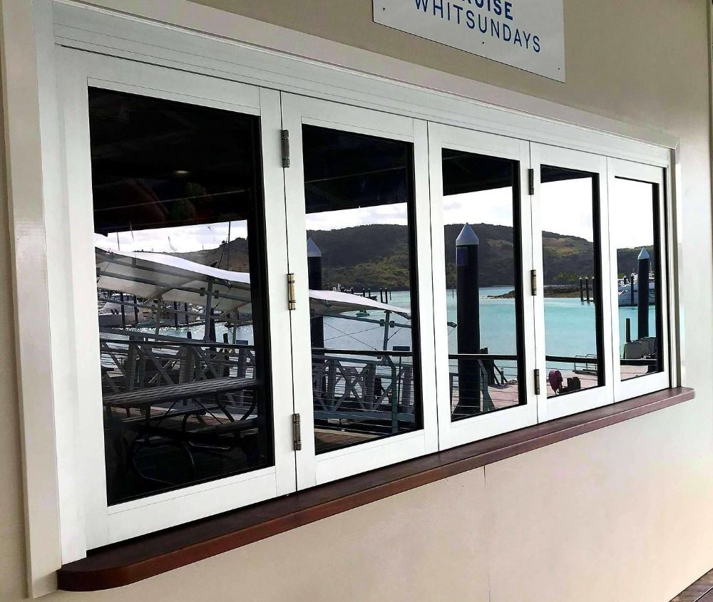 A Large Window with A Sign Above It that Says ' White Sundays ' — North Queensland Glass & Glazing In Cannonvale, QLD