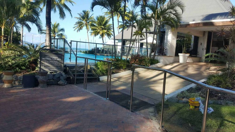 A Stainless Steel Railing Leading to A Swimming Pool — North Queensland Glass & Glazing In Proserpine, QLD