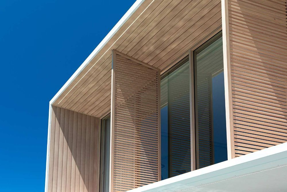 A Building with A Lot of Windows and A Blue Sky in The Background — North Queensland Glass & Glazing In Cannonvale, QLD