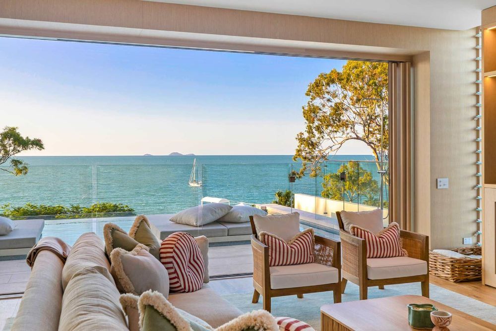 A Living Room with A Couch and Chairs and A View of The Ocean — North Queensland Glass & Glazing In Cannonvale, QLD